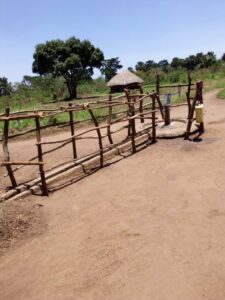 Borehore surrounded by wooden frames, with a hut in the background